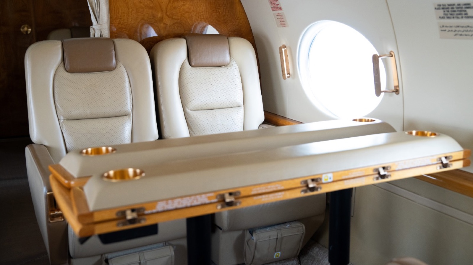 Gulfstream G450 pair of seats with the wood conference table deployed