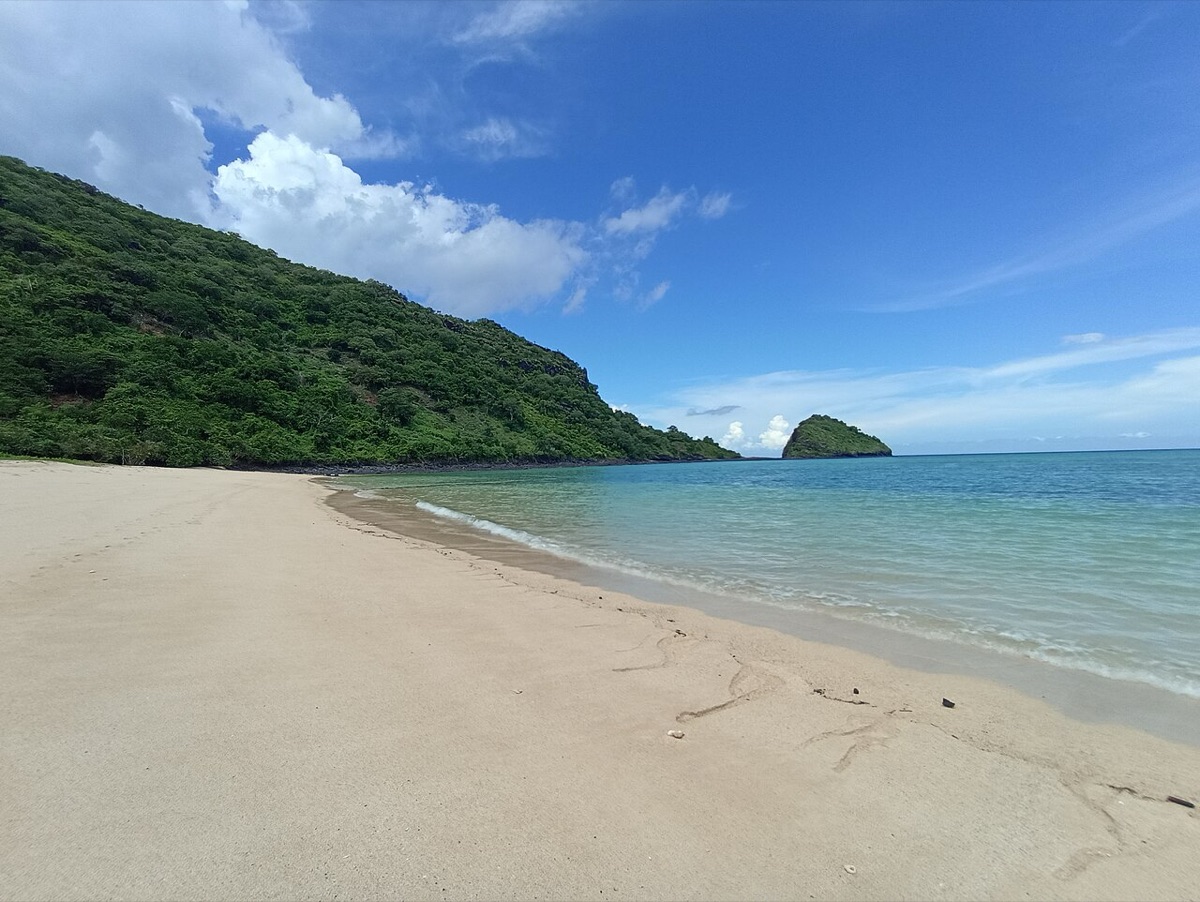 Mayotte — an empty white-sand beach and offshore islet inside the lagoon